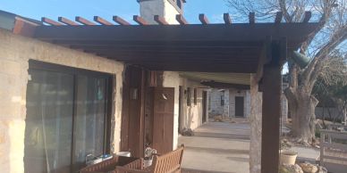 Porch area with wooden benches and rustic architecture.