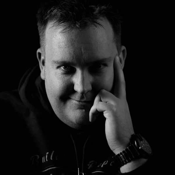 Black and white portrait of a man with a thoughtful expression.