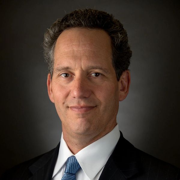 Professional portrait of a man in a suit and tie.