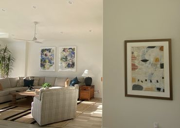 Bright and cozy living room with abstract art and comfortable seating.