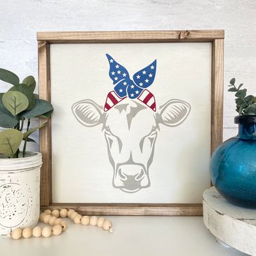 Handcrafted wood sign of a patriotic cow