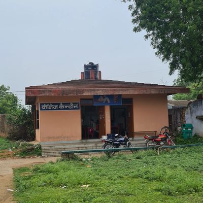 Small college canteen building with motorcycles parked outside.