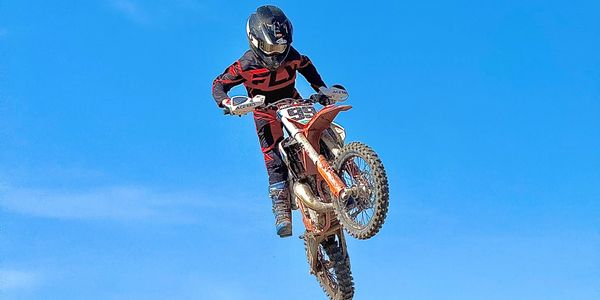 Youth rider launching through the air.
