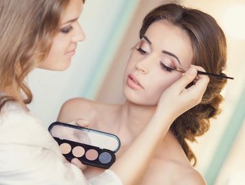 A makeup artist doing eye makeup for client