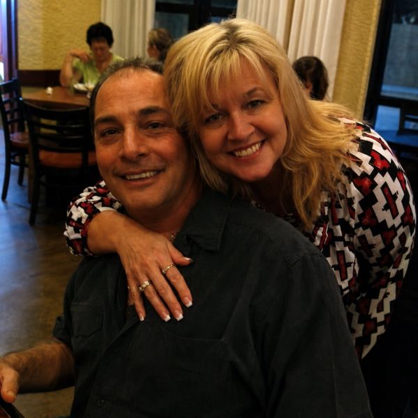 Smiling couple posing in a restaurant.