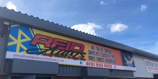 Outdoor sign for Reid Auto with contact info.