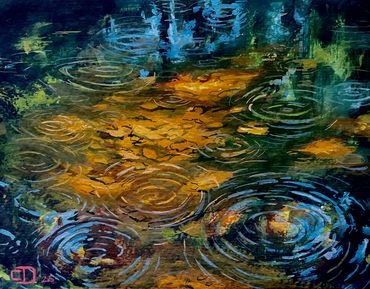 Colorful ripples on water surface after rain.