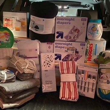 Variety of household essentials including diapers, cleaning products, and kitchen tools.