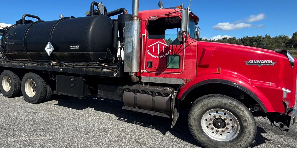 Gateway Petroleum Vac Truck image.  Red Kenworth Truck with vacuum hoses with Gateway Petroleum logo