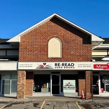 Facade of Re-Read Used Books store with clear signage on a sunny day.