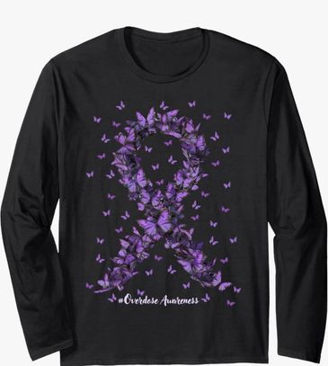 Black long sleeved, with purple butterflies to make the ribbon. 