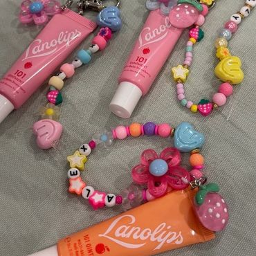 Colorful Lanolips tubes with beaded keychains and charms.