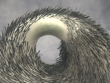 One circular spiky art piece with a hole in the centre.