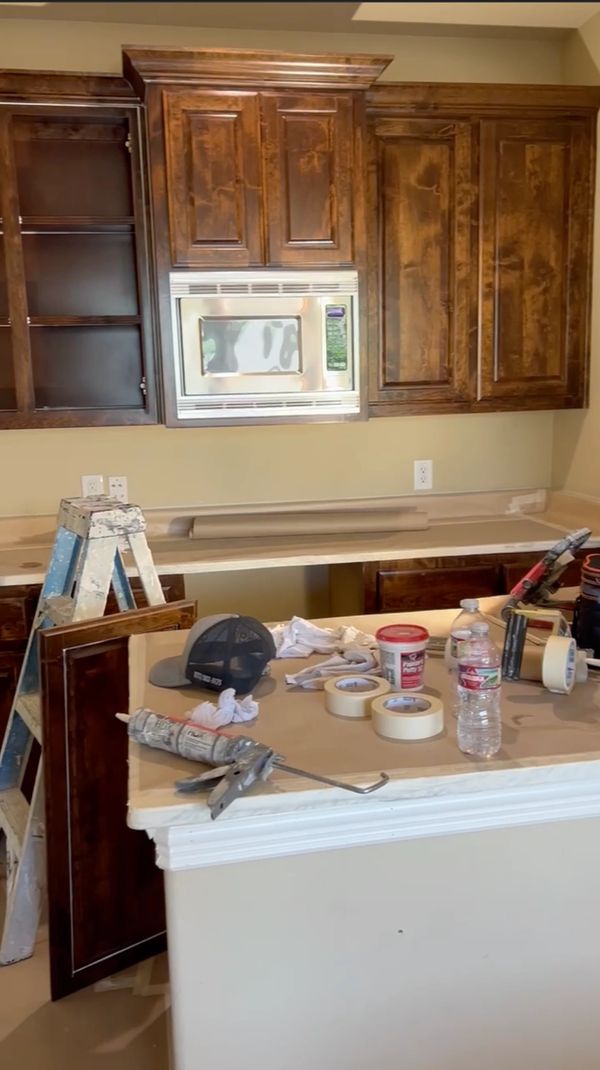 Kitchen renovation in progress with tools and materials on the counter.