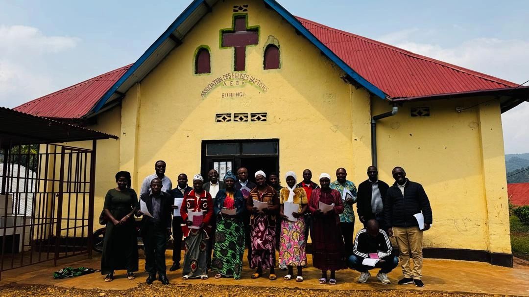 Group of people standing outside a church building.