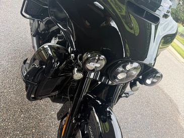 Close-up of a sleek black motorcycle parked on a street.