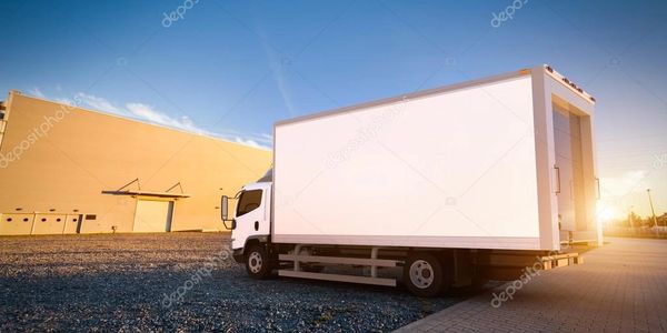 White Moving Truck in front of wharehouse