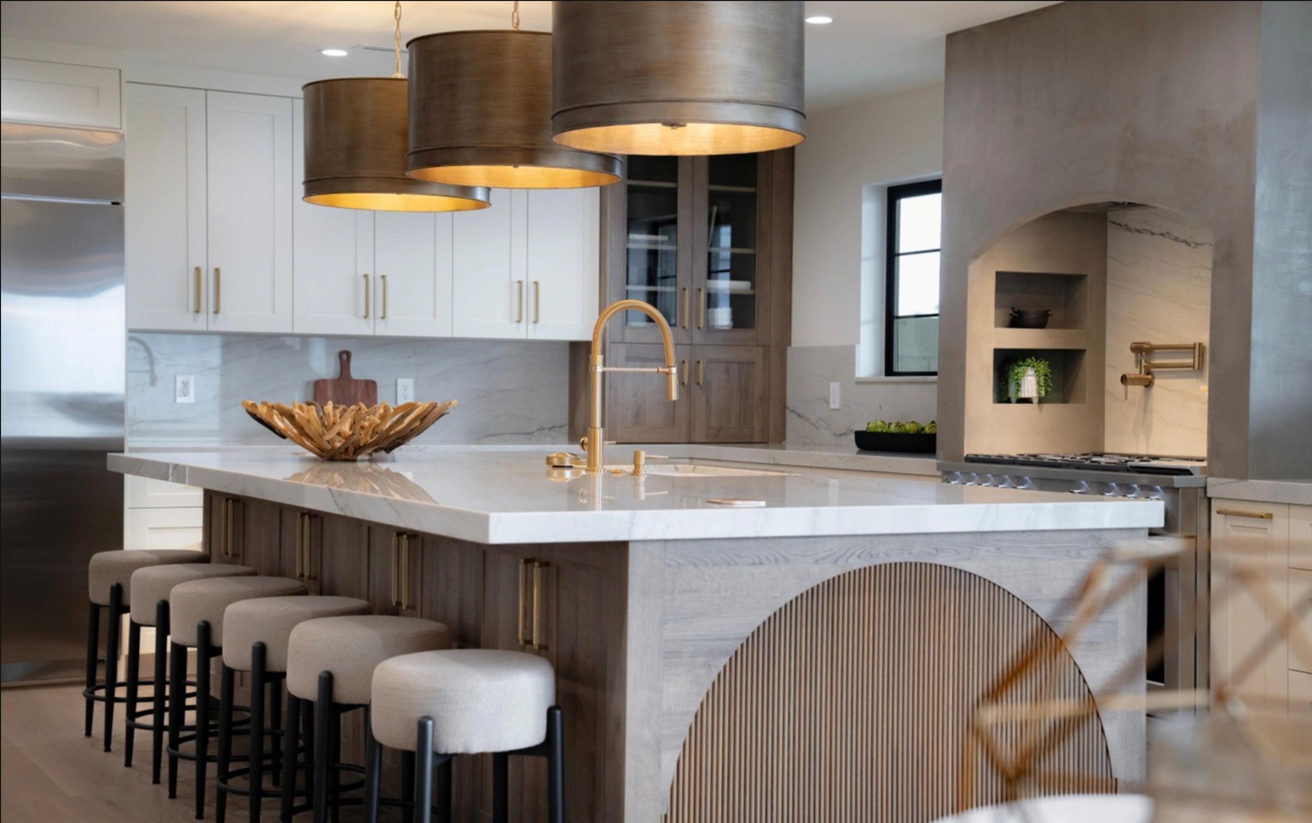 Modern kitchen island with elegant bar stools and pendant lights.