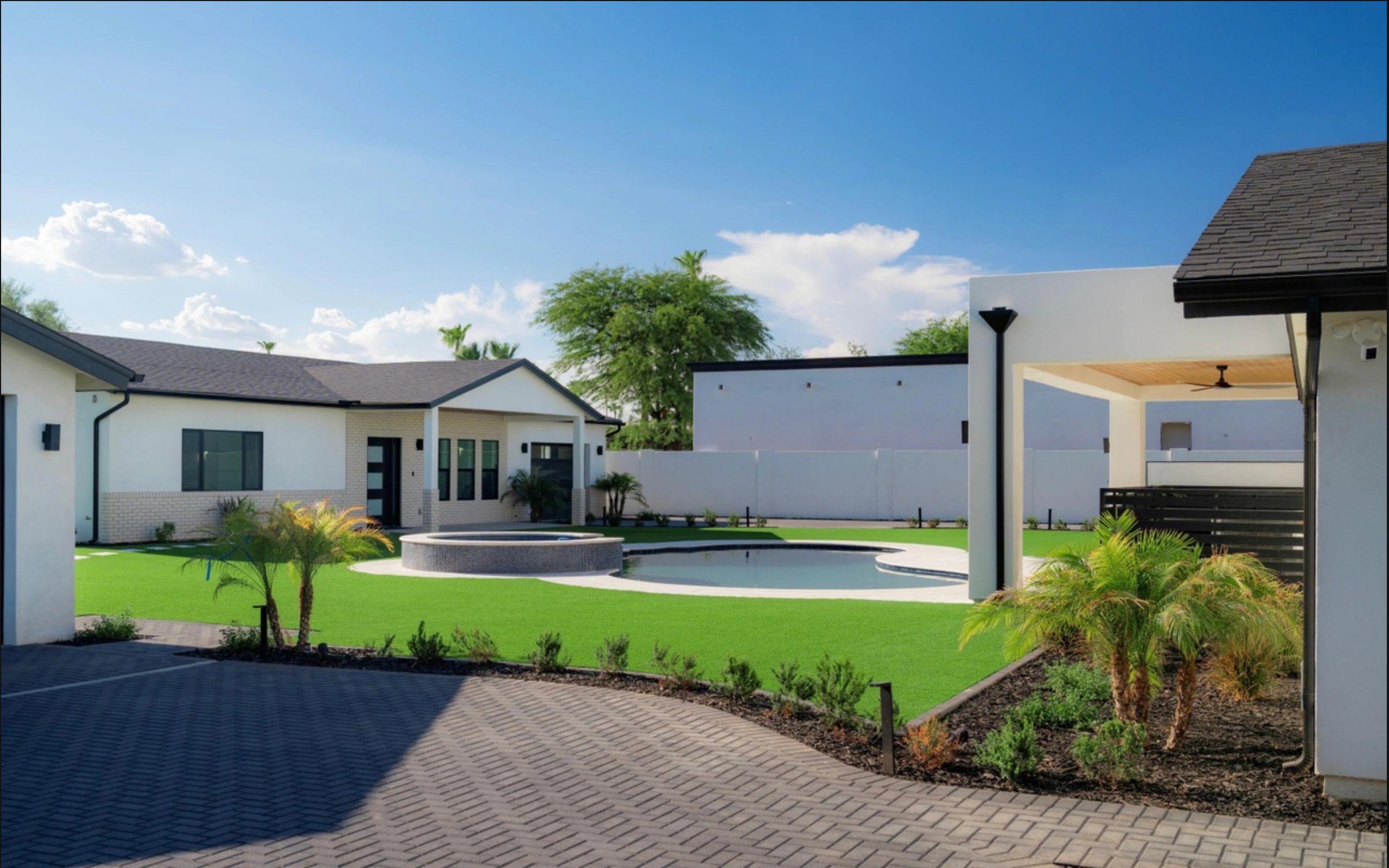 Modern backyard with pool and well-maintained lawn.