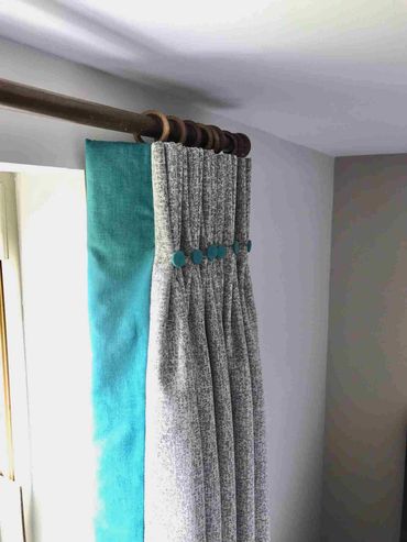 interlined, double pleated curtains with a contrast leading edge and matching buttons