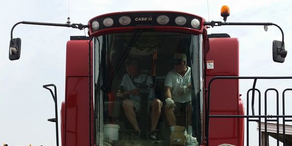 Todd in the driver seat beside his dad Chuck getting ready for harvest!
