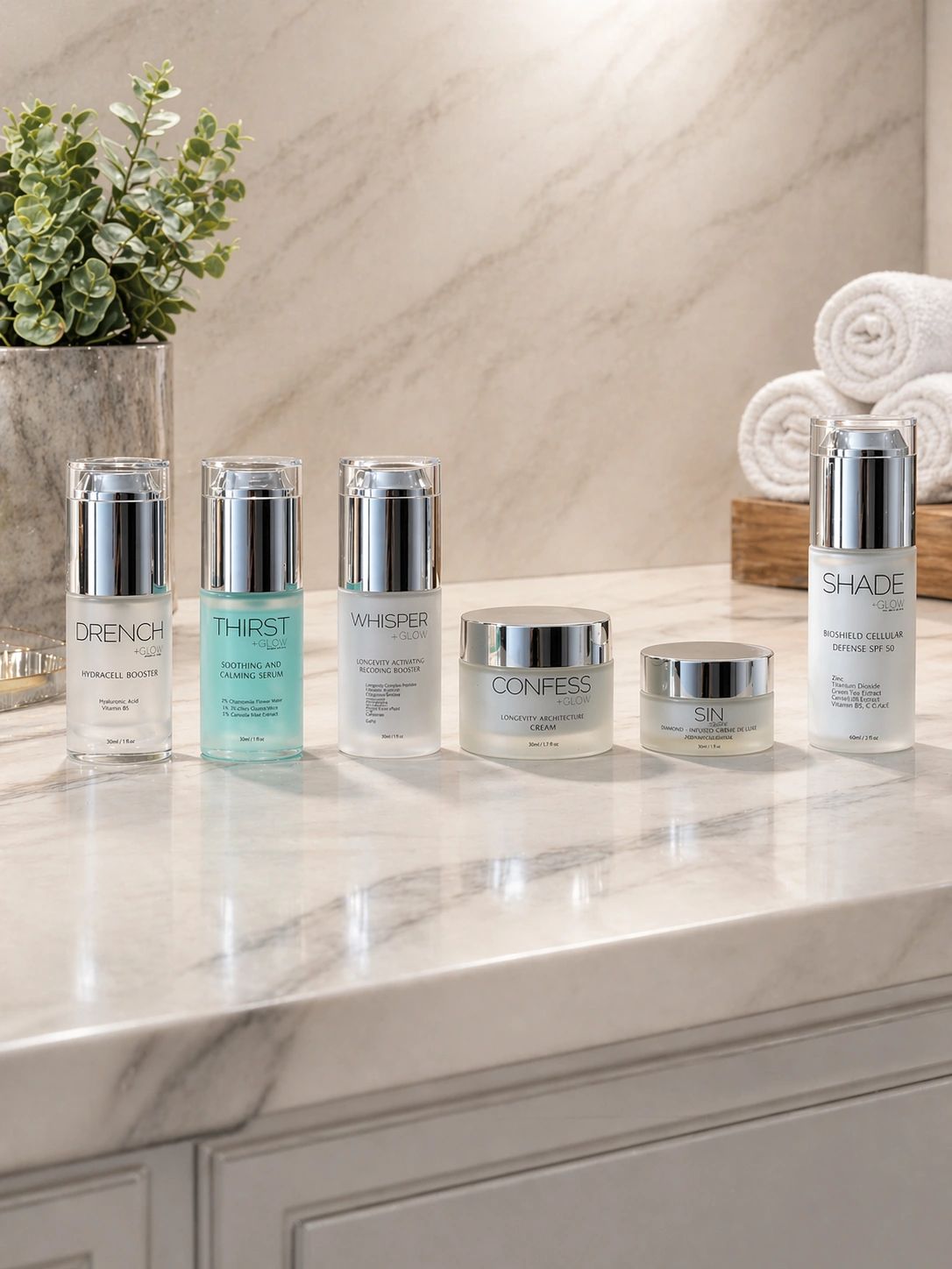 Skincare products lined up on a marble countertop.