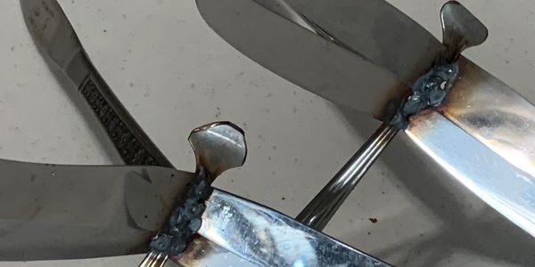Close-up of metal propeller blades with weld marks.