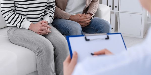 a couple nervously awaits their STD/STI test results.