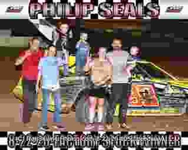 Racing team celebrates victory by their car.
