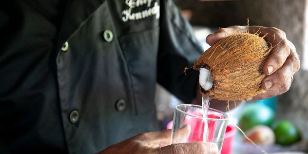 Coconut water being poured into a clear glass