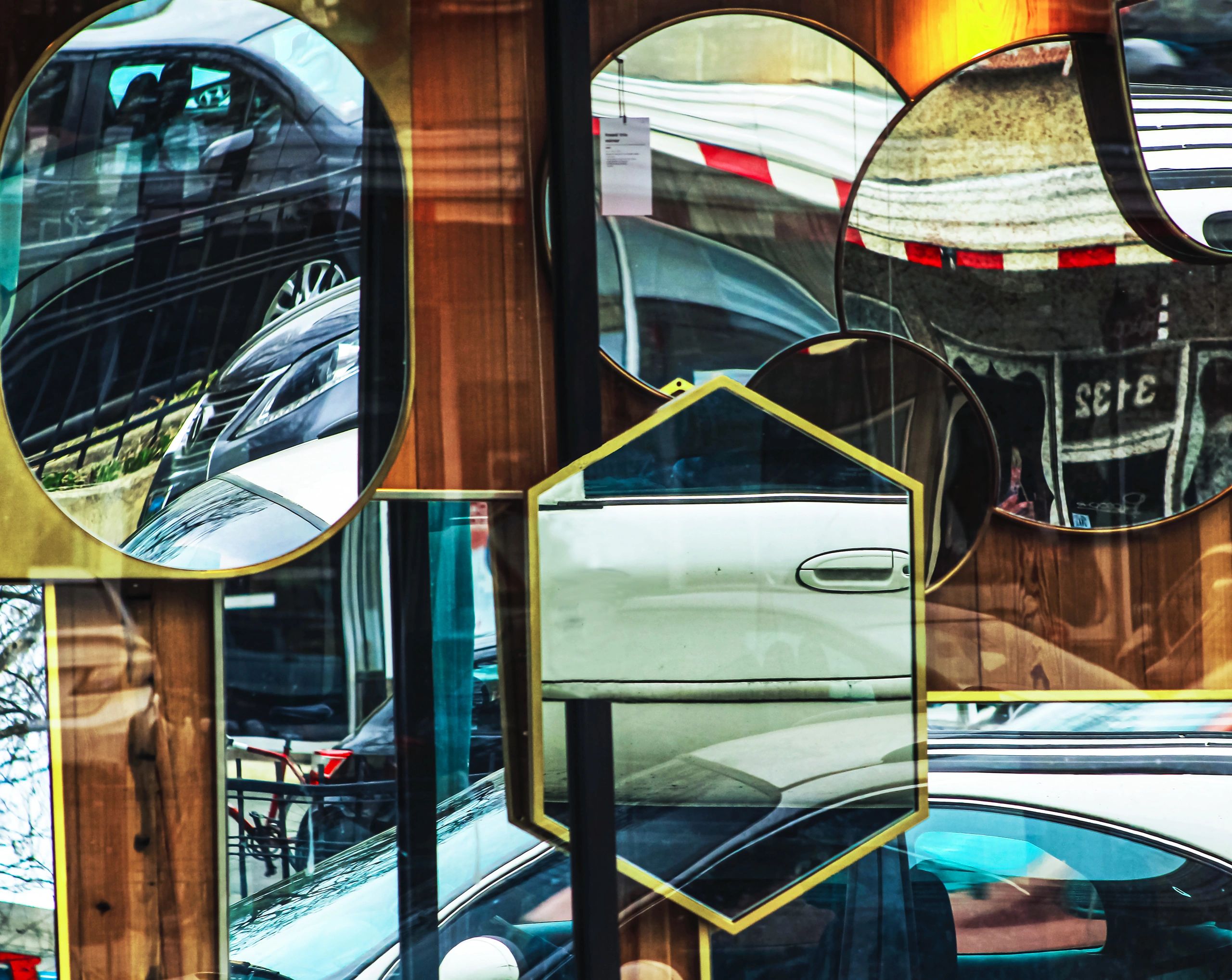Multiple mirrors reflecting cars and surroundings.