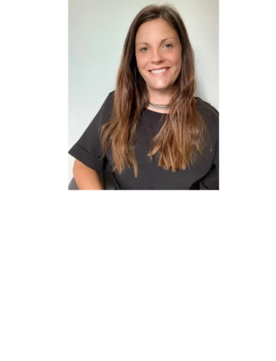 Smiling woman with long brown hair in black shirt.
