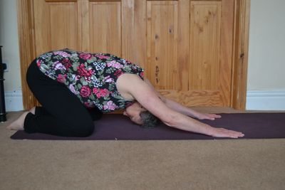 Practising child’s pose easy  yoga posture