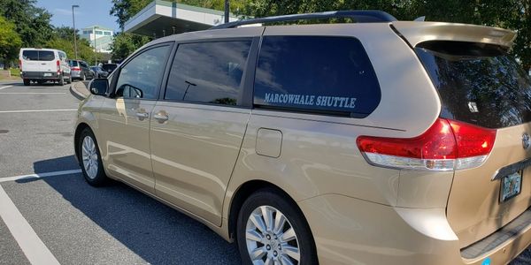 Side view of the Marcowhale Shuttle text on the car glass
