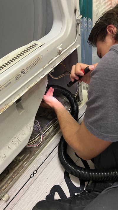 MSJ Appliance Repair technician repairing a washing machine in a customer's home