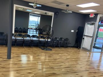 Empty room with chairs and a fan.