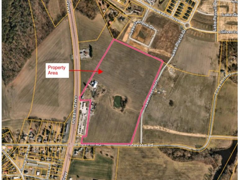 Aerial view of land with marked property area.