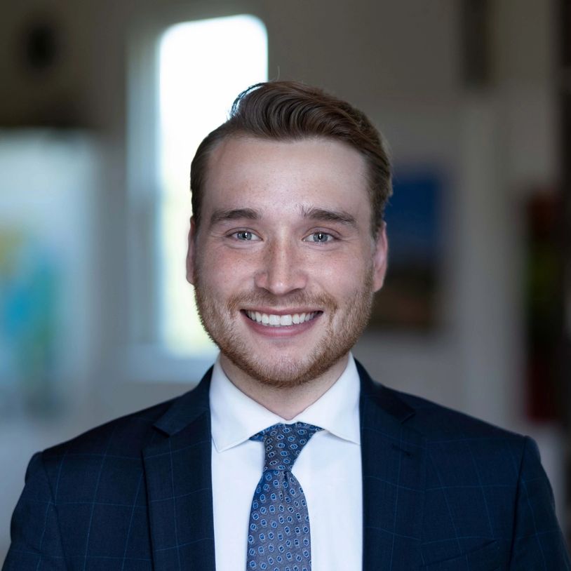 Smiling man in suit and tie.