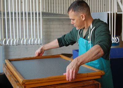 Don Widmer paper artist creating a sheet of handmade paper