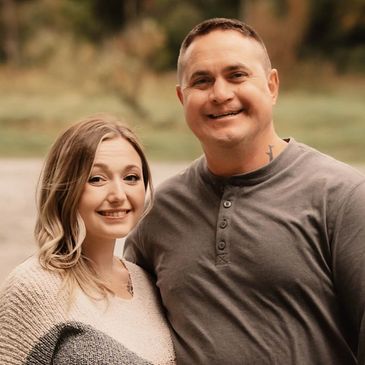 Smiling couple outdoors.