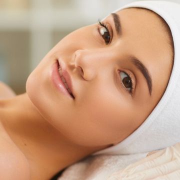 women's face smiling with a very clean and soft skin after a facial 