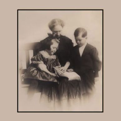 Vintage photo of a woman reading to two children.