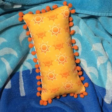 Fun with fabrics. Customer supplied pom poms trim and this sunny fabric to back her mini pillow.