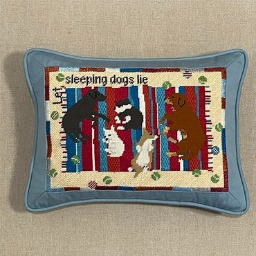 Our needlepoint pillow finisher framed the canvas in blue fabric and backed it in stripes