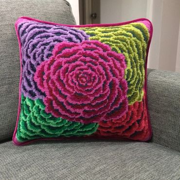 Needlepoint pillow finished with velvet  welting and contrasting silver backing