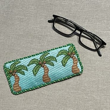 Needlepoint eyeglasses case finished with twist cord trim