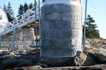 Removing paint from granite lighthouse foundation.

