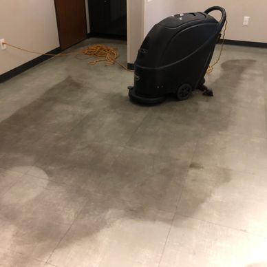 Floor machine before and after.  Before shows stained floor and after shows clean floor. 