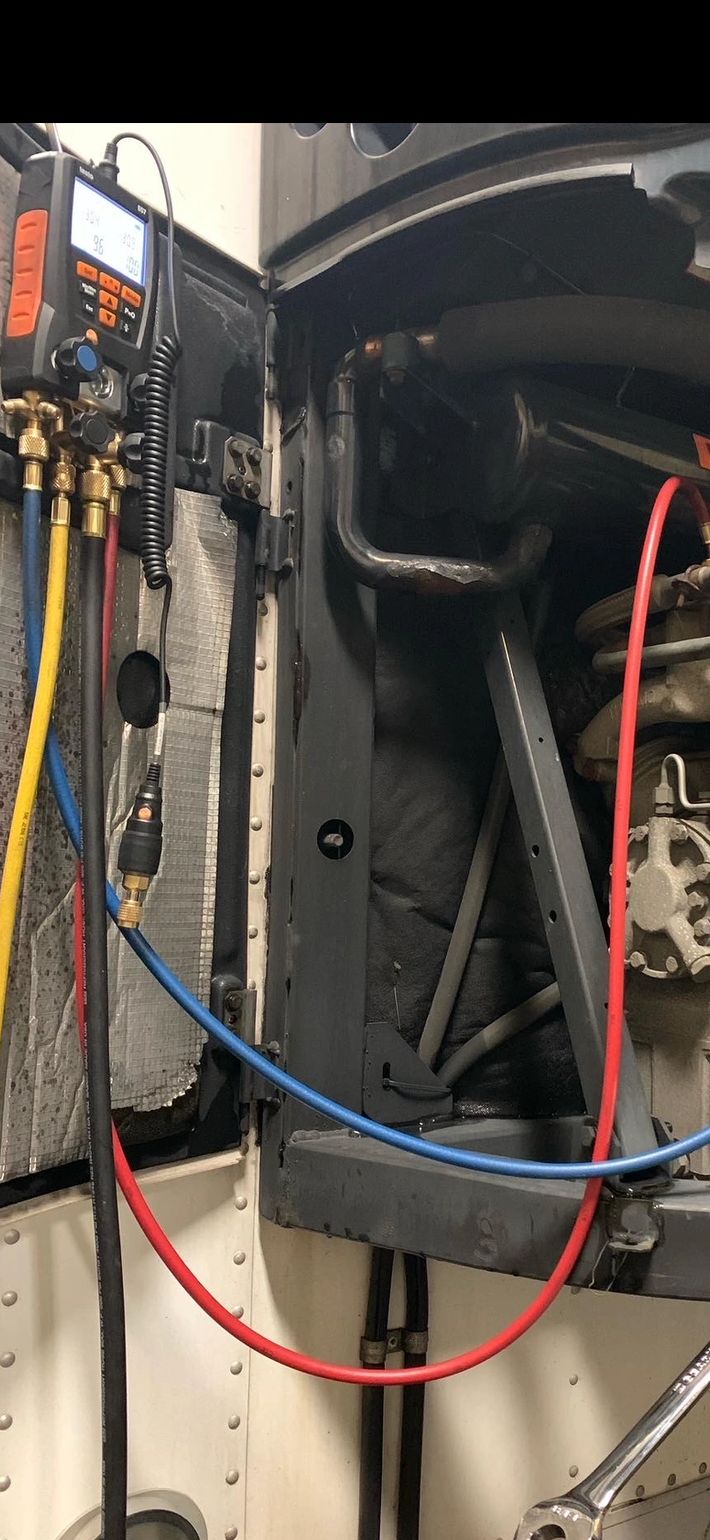 Checking refrigerant in a Thermo King reefer unit during a roadside assistance call. 
