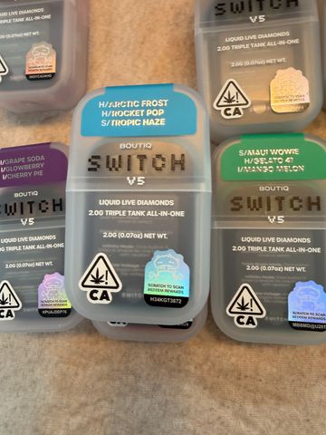 Various Switch V5 liquid live diamond cannabis cartridges with different strain labels.